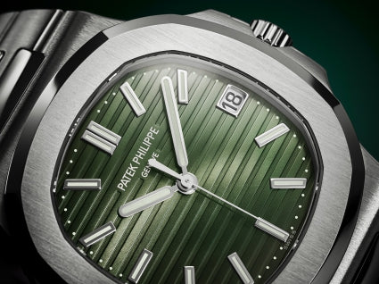 Patek Philippe Nautilus 57 watch with green face and silver case on a dark background1