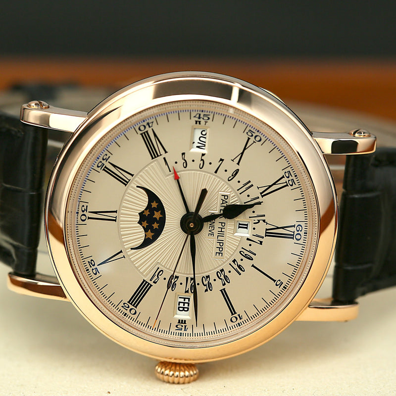 Patek 5159G watch with detailed face and black strap on a neutral background