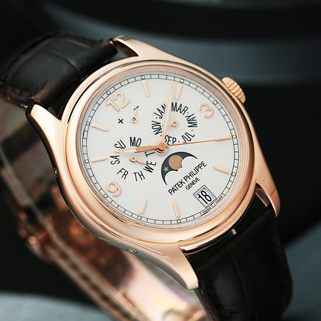 PatekPhilippe5146G with rose gold case and black leather strap on a dark background