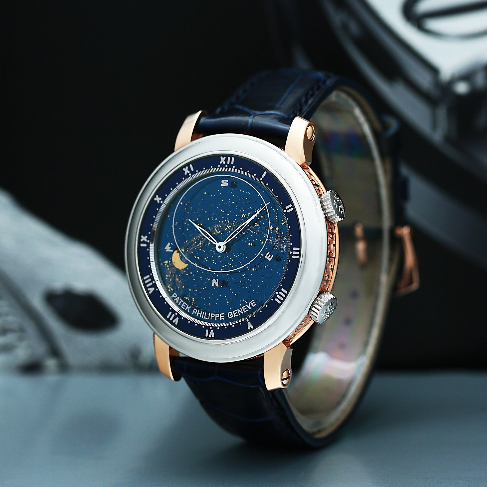 Patek Philippe 5102 with blue face and black leather strap on a dark background