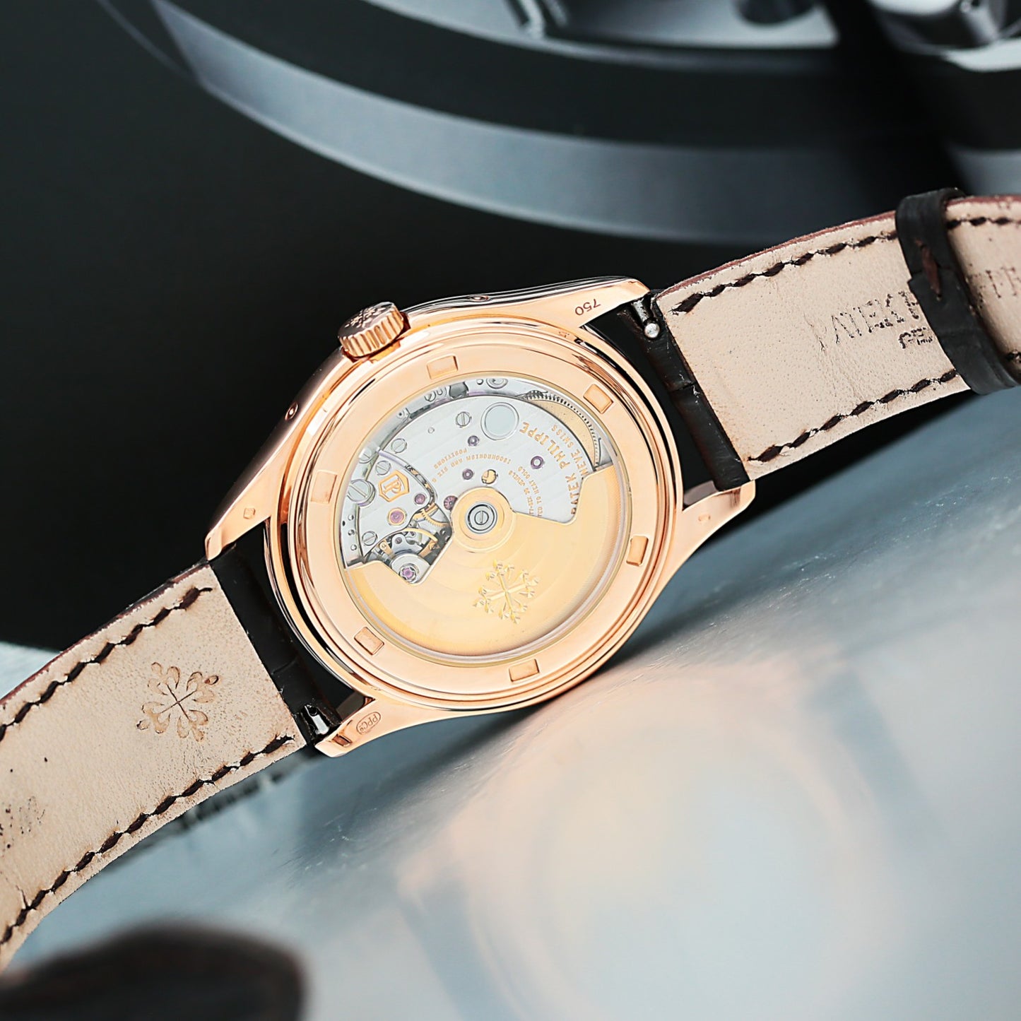 Patek Philippe 5146R with rose gold case and beige leather strap on a dark background