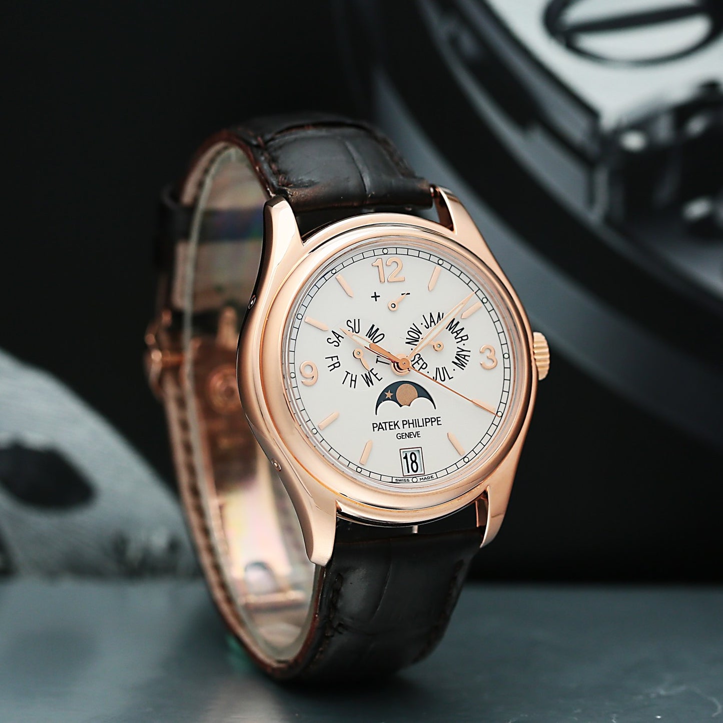 Patek Philippe 5146G with black leather strap and rose gold case on a dark background