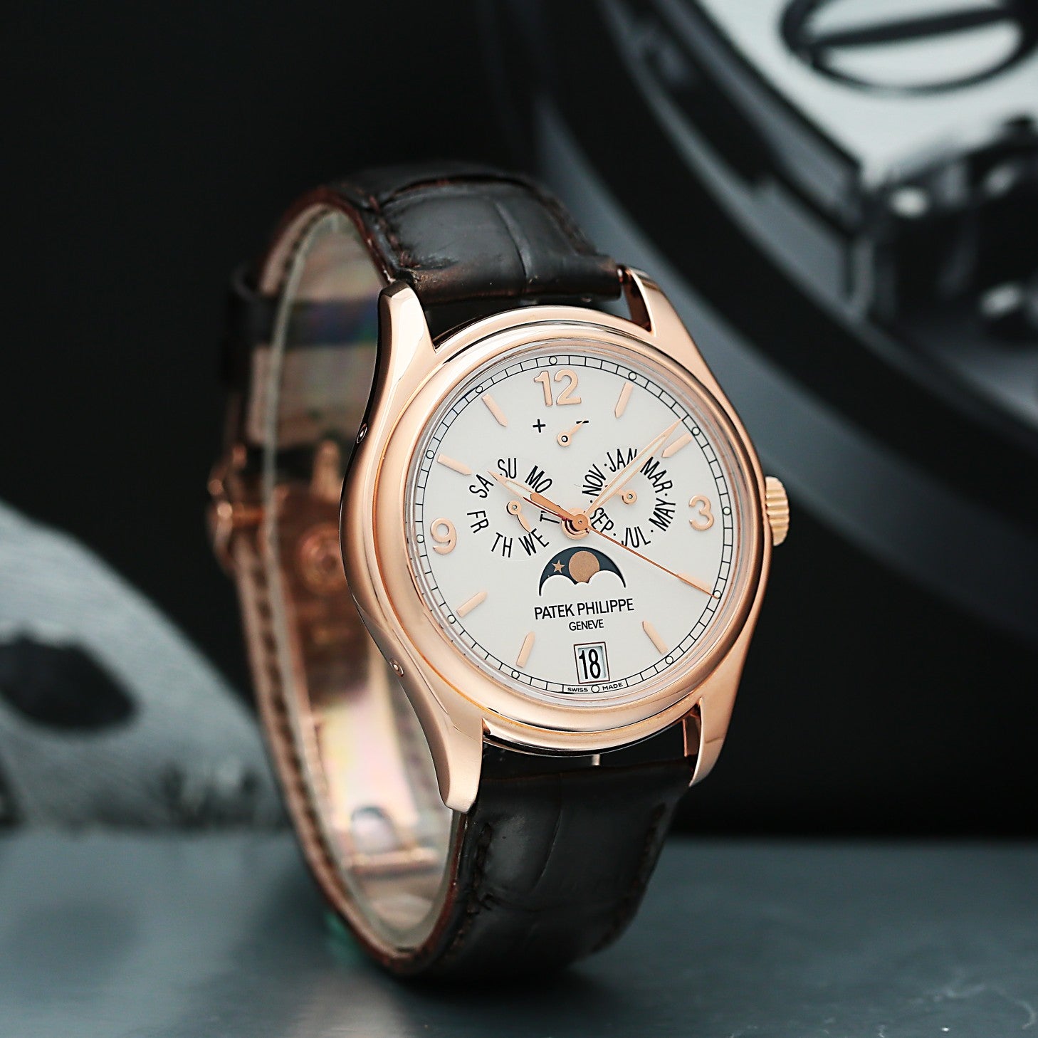 Patek Philippe 5146G with black leather strap and rose gold case on a dark background