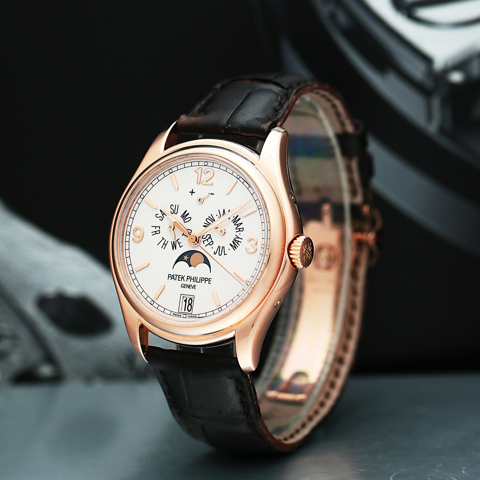 Patek Philippe 5146G with black leather strap and rose gold case on a dark background